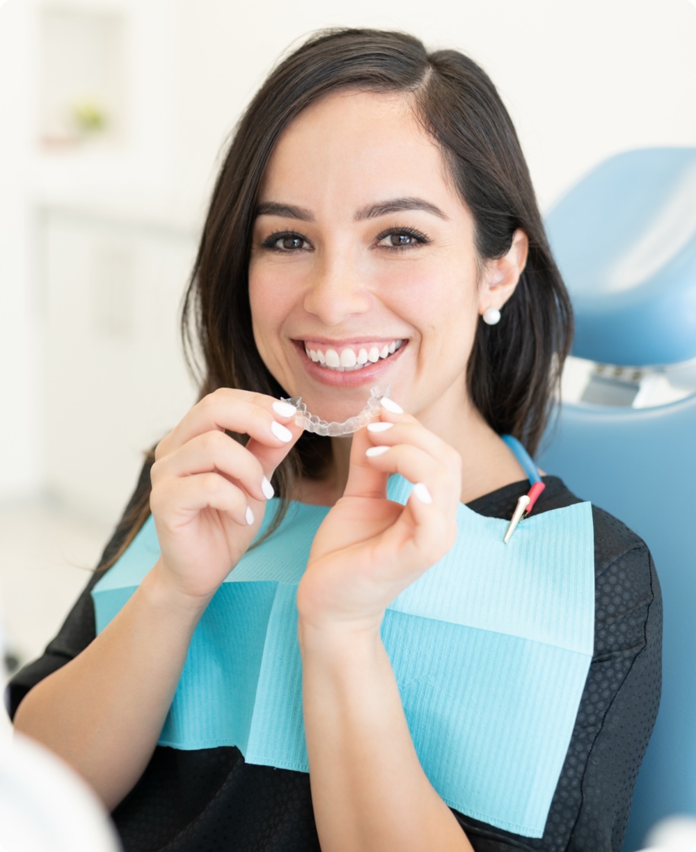 Patient holding clear aligners